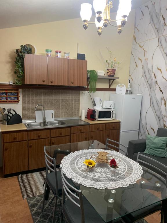 a kitchen with a table and a kitchen with a microwave at O Recanto do Sossego in Mértola