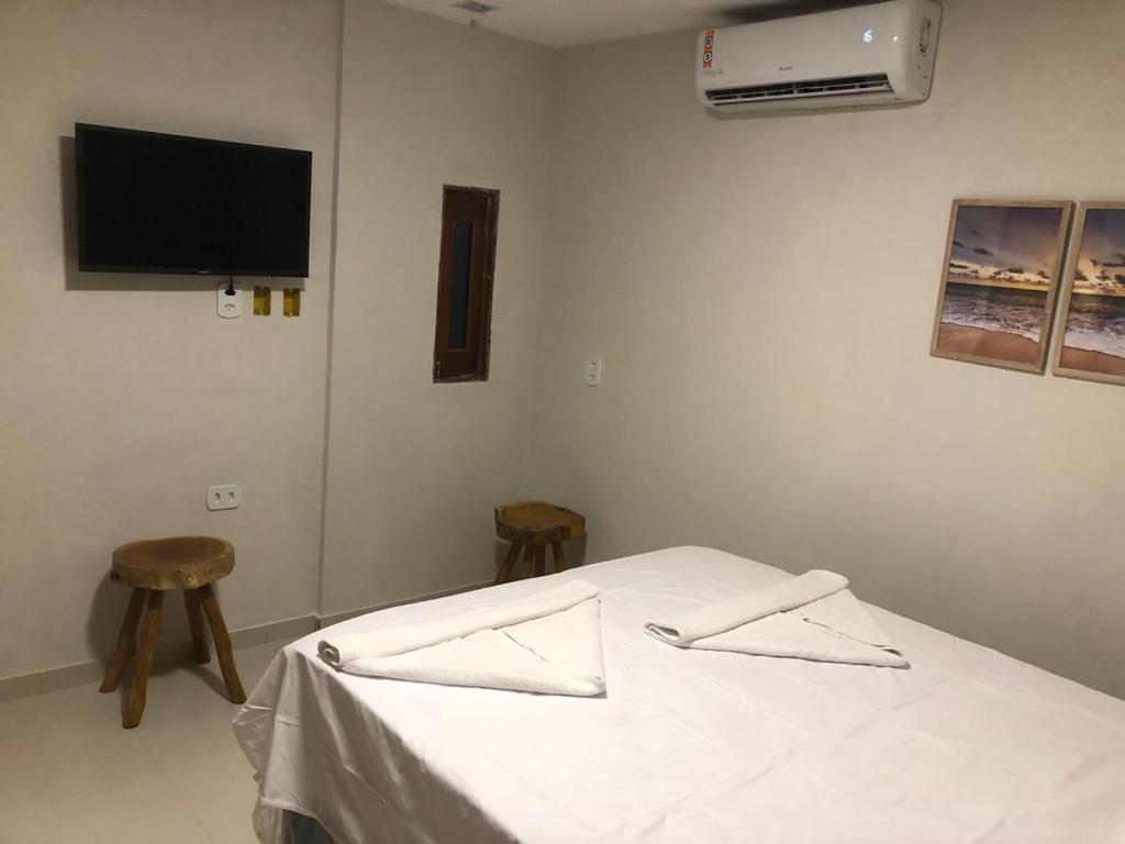 Ένα ή περισσότερα κρεβάτια σε δωμάτιο στο Apto Pajuçara 01
