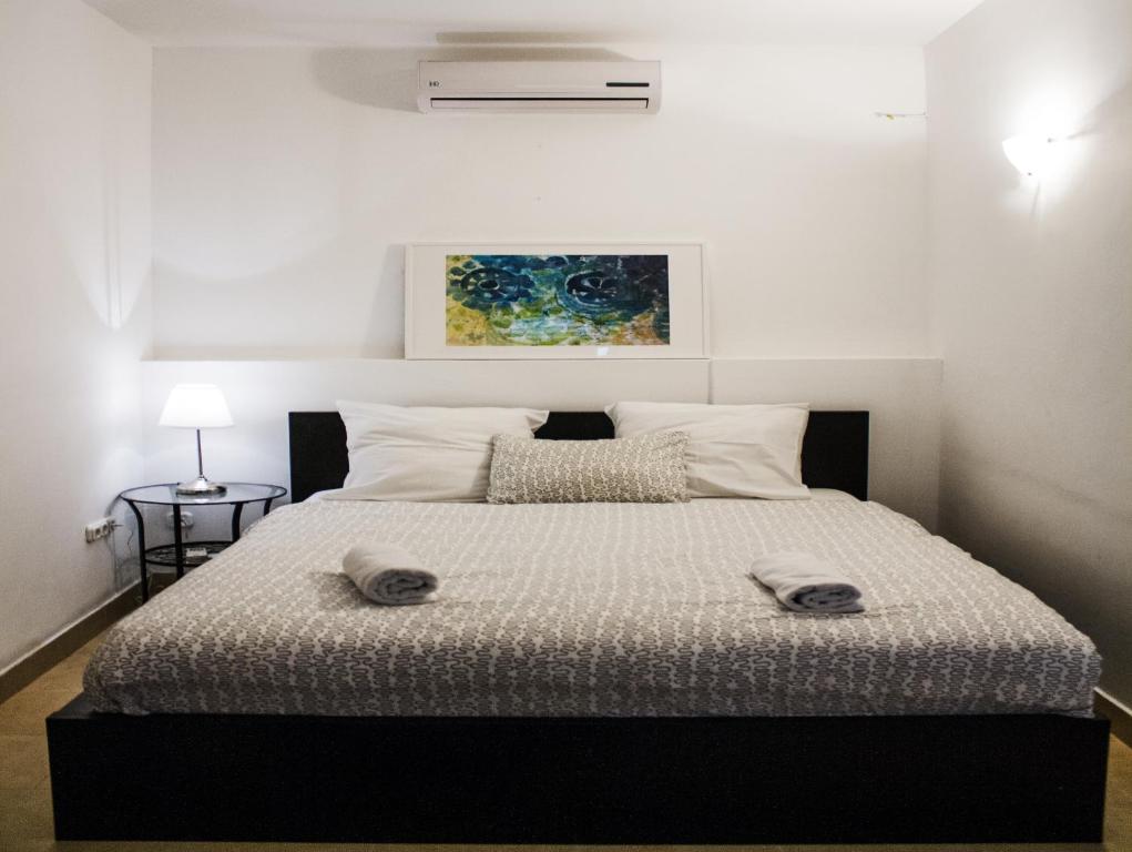 a bedroom with a bed with two towels on it at Travel Inn Apartments in Budapest