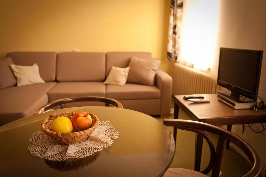 a bowl of fruit on a table in a living room at Ubytování U Kroupů in Deštné v Orlických horách