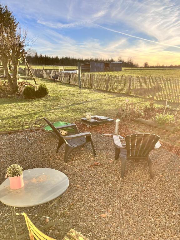 a patio with a table and two chairs and a table at Les Pierris in La-Roche-en-Ardenne