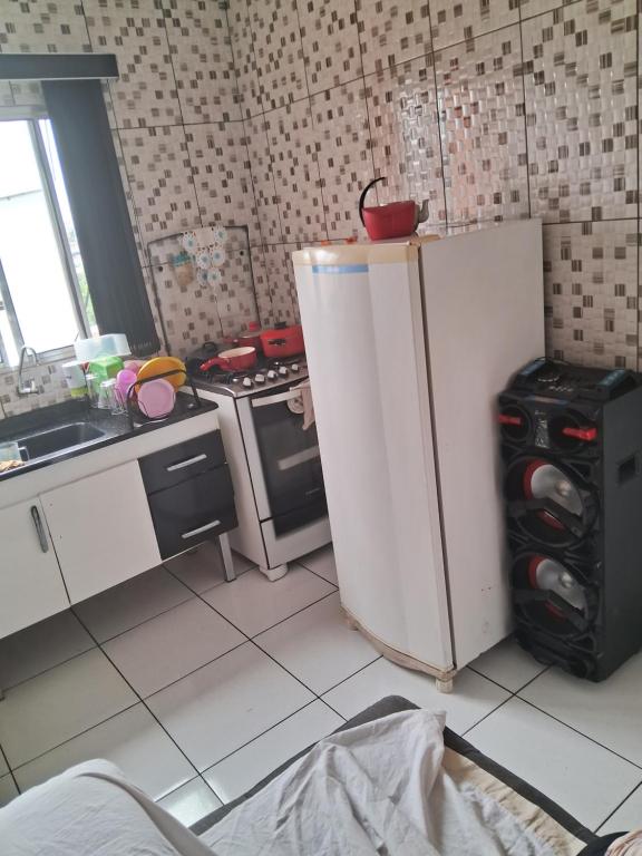 a small kitchen with a refrigerator and a stove at Casa da laje in Sao Paulo