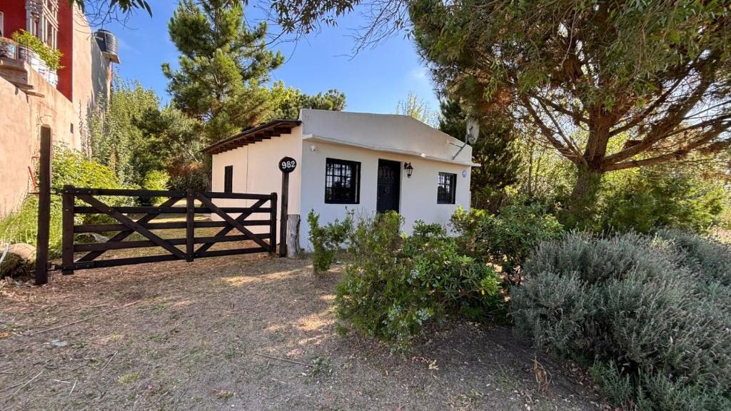 a small white building with a gate and a fence at casa en costa del este para 5 personas in Costa del Este