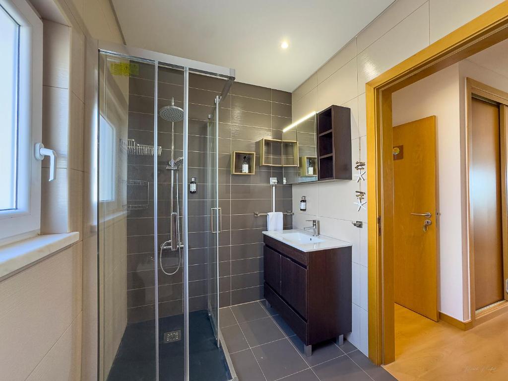 a bathroom with a shower and a sink at Vibing & Liming Ericeira in Ericeira
