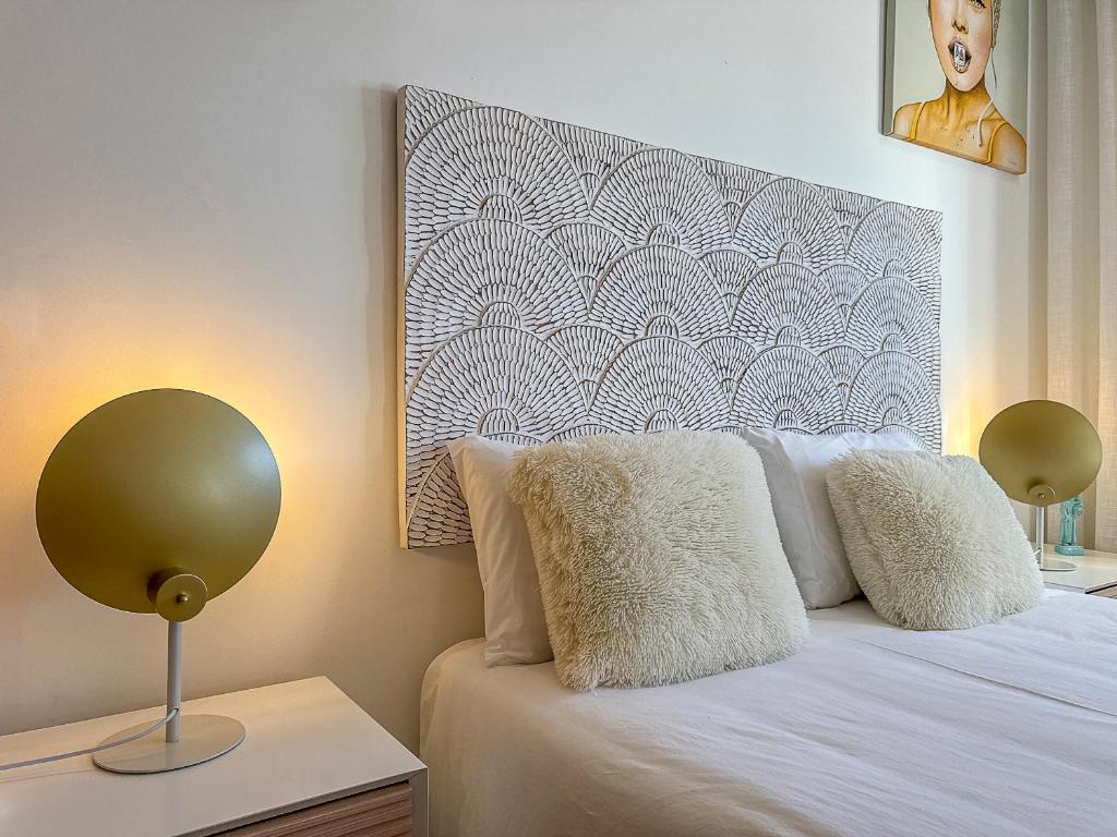 a bedroom with a bed with two lamps on it at Vibing & Liming Ericeira in Ericeira