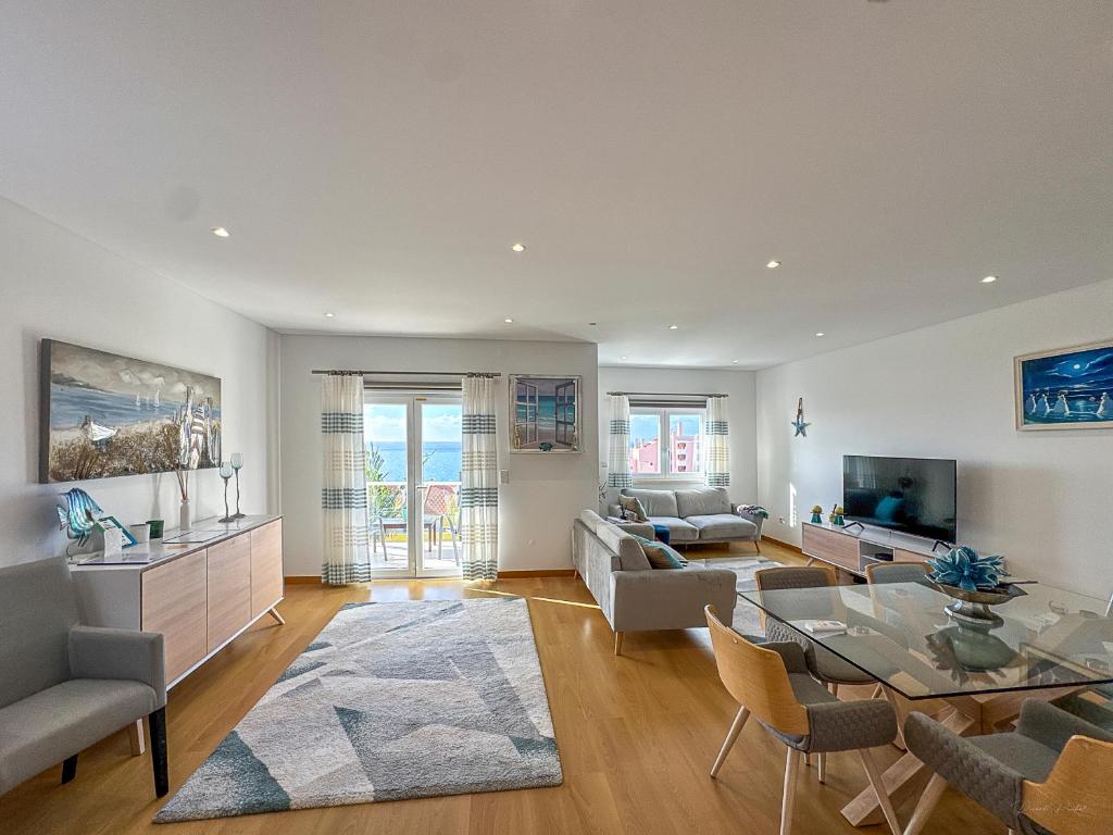 a living room with a couch and a table at Vibing & Liming Ericeira in Ericeira