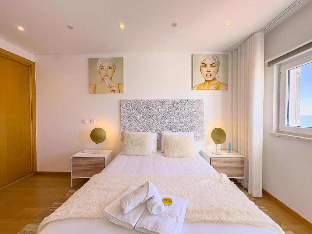a bedroom with a large bed with two night stands at Vibing & Liming Ericeira in Ericeira