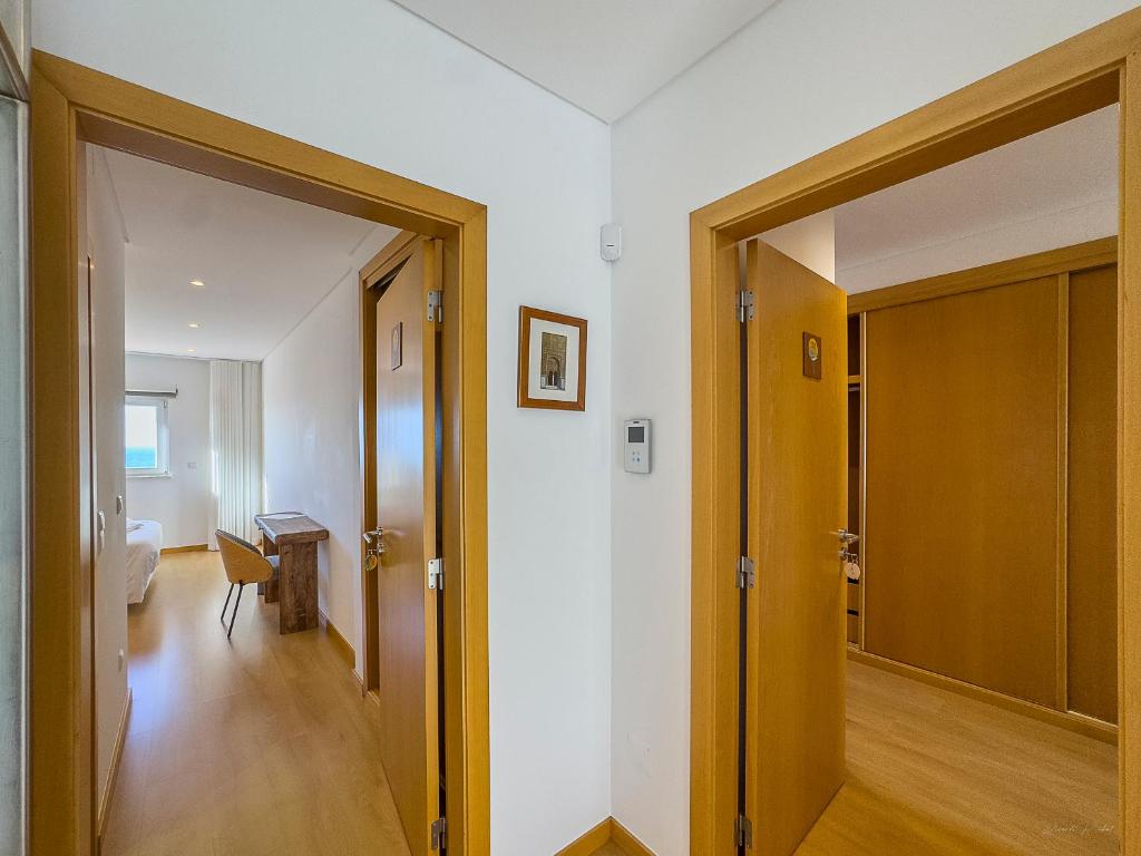 an open door to a room with a hallway at Vibing & Liming Ericeira in Ericeira