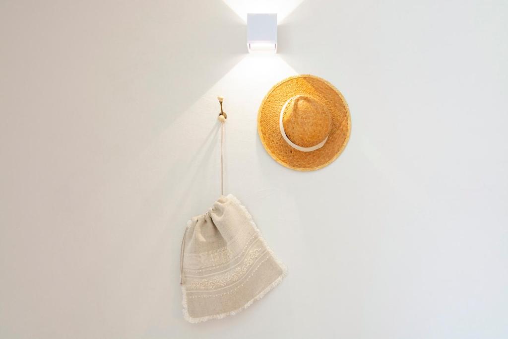 a hat and a bag hanging on a wall at Casa da Zanjas in Seia