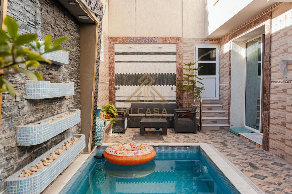 a patio with a swimming pool and a house at Apartment Nazaha for families only in Tangier