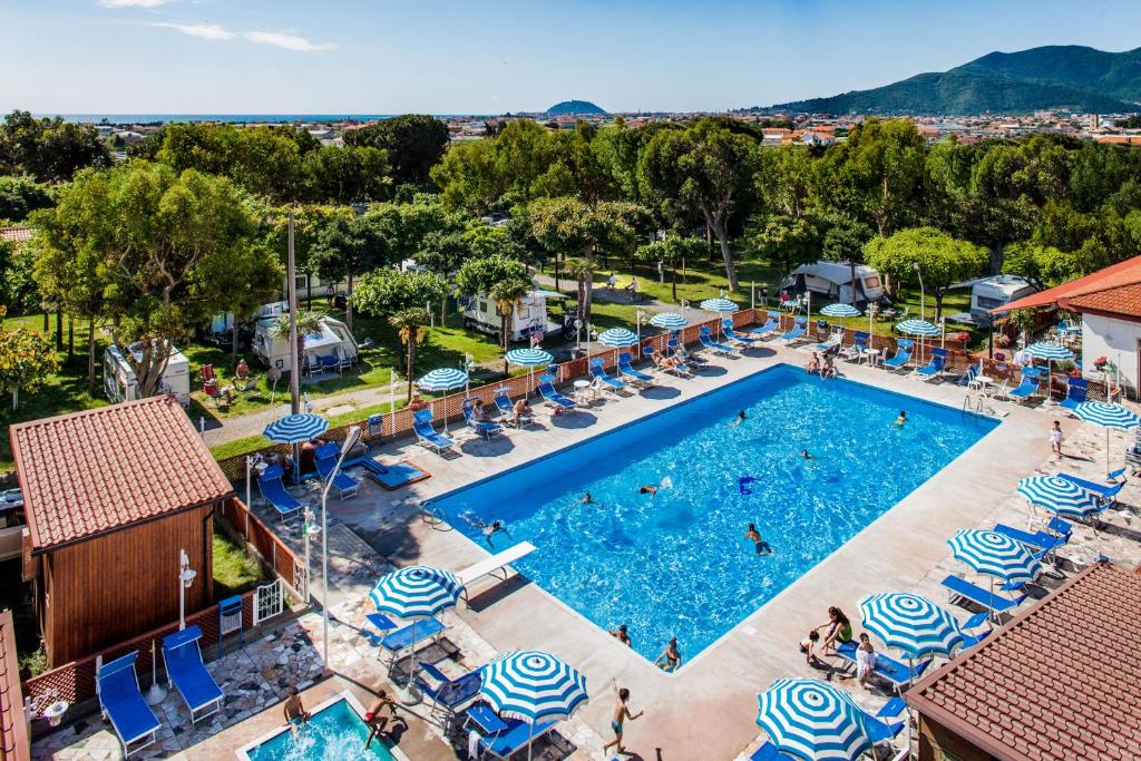 una vista aérea de una piscina con sillas y sombrillas en Camping Baciccia en Ceriale