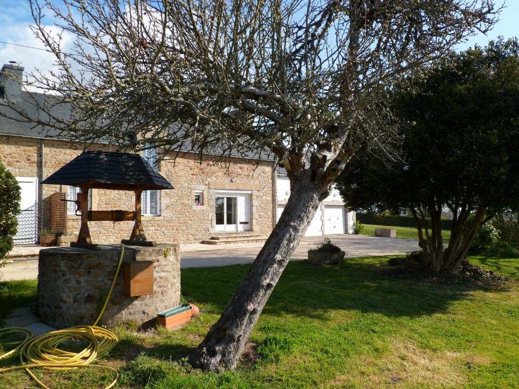 a tree and a house with a hose at Farmhouse in an amazing private park in Vannes