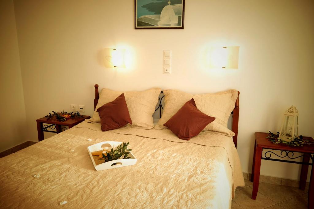 a bedroom with a bed with a box of flowers on it at Aggelos Studios in Agios Prokopios
