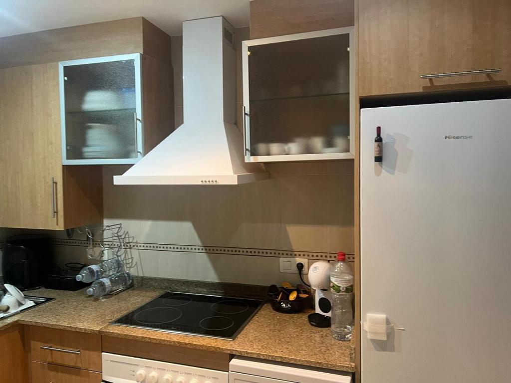 a kitchen with a sink and a stove top oven at Torremar - Magic World - Marina d'or in El Borseral