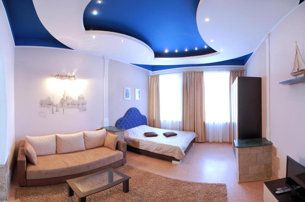 VIP on Naberezhnaya str في نيكولايف: غرفة معيشة ذات سقف أزرق وأريكة