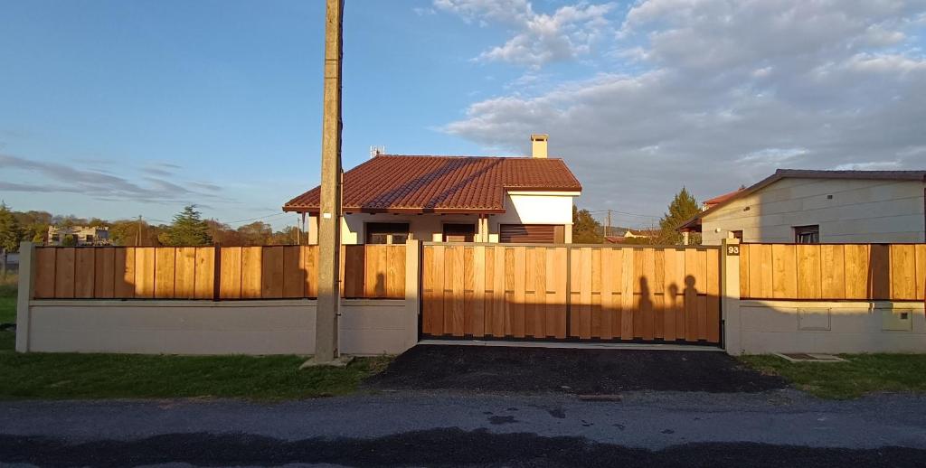 a wooden fence in front of a house at Casa da Braña in Teo