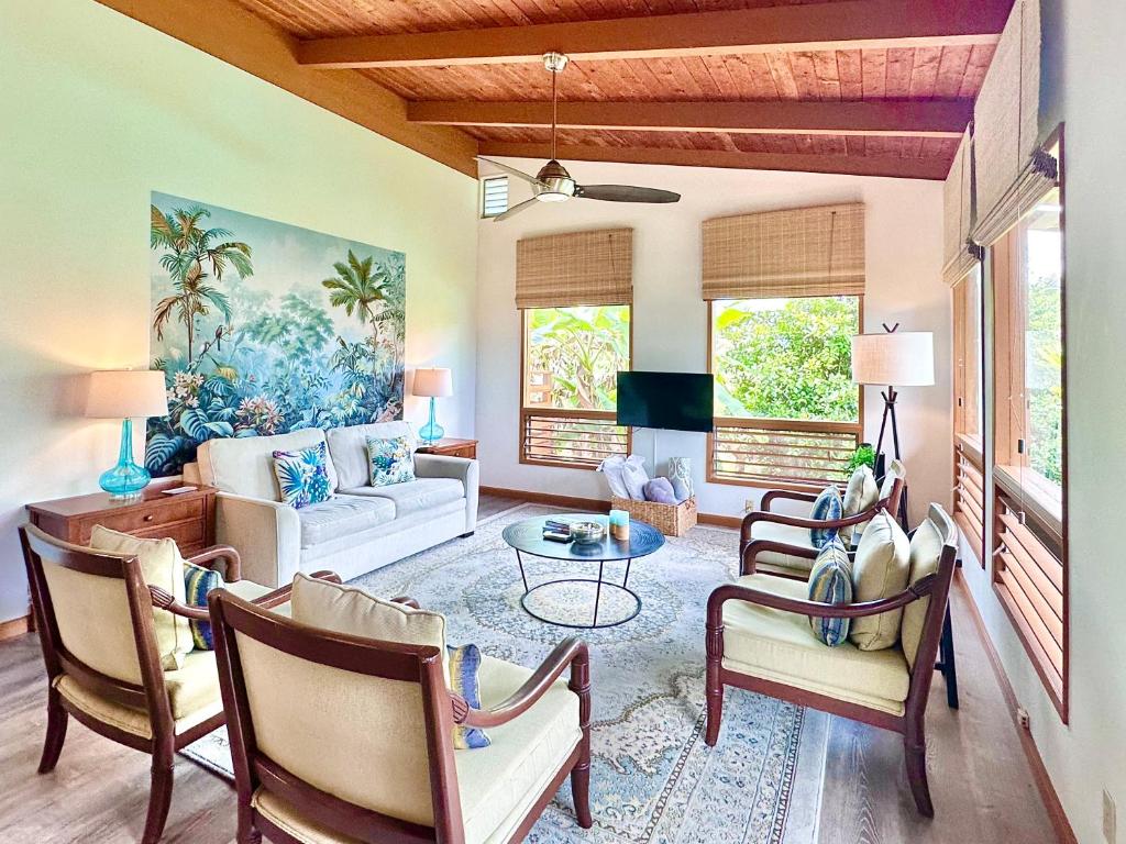 a living room with a couch and a table at Puna Zen Botanical Garden Retreat in Keaau