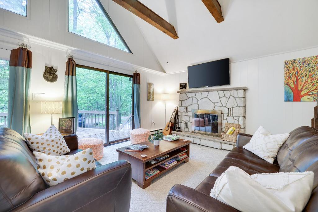 a living room with leather furniture and a fireplace at Pocono Cabin Fireplace Near Skiing Tubing Parks Shopping Casinos in Pocono Lake