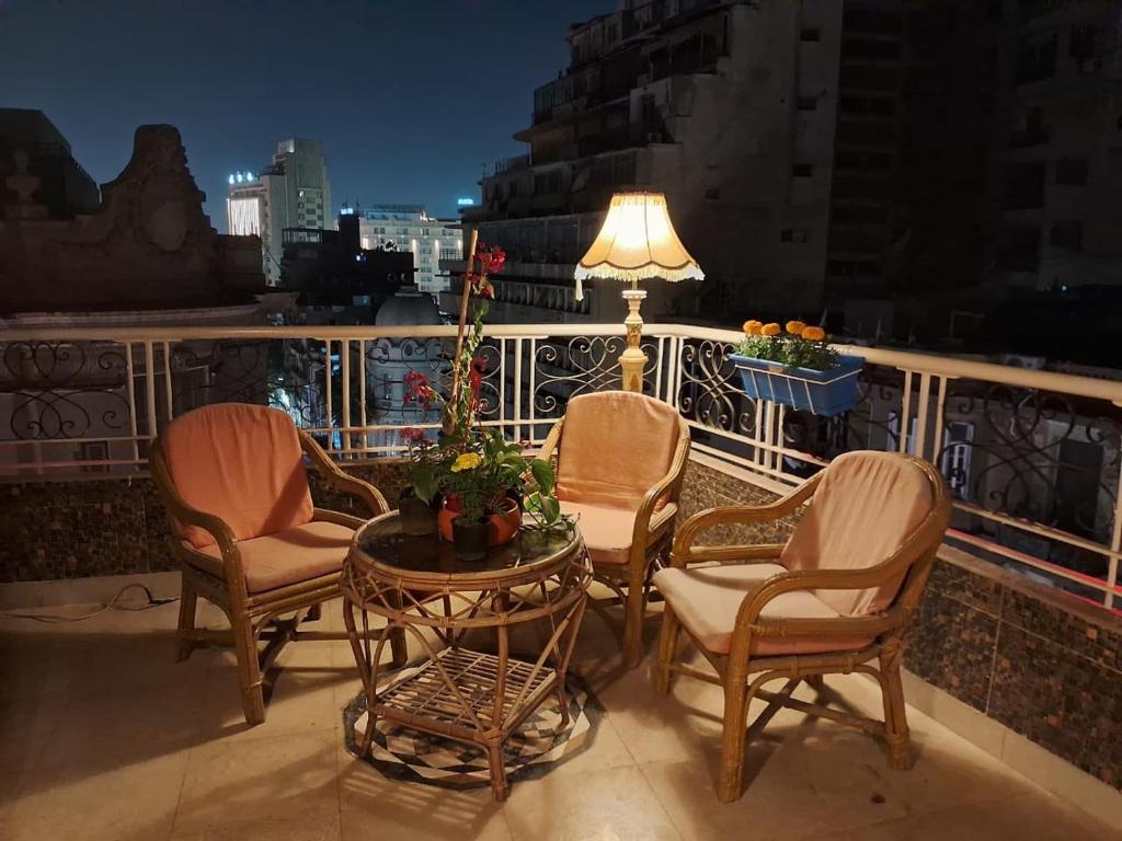 a group of chairs and a table on a balcony at 15 Bustan Down town in Cairo