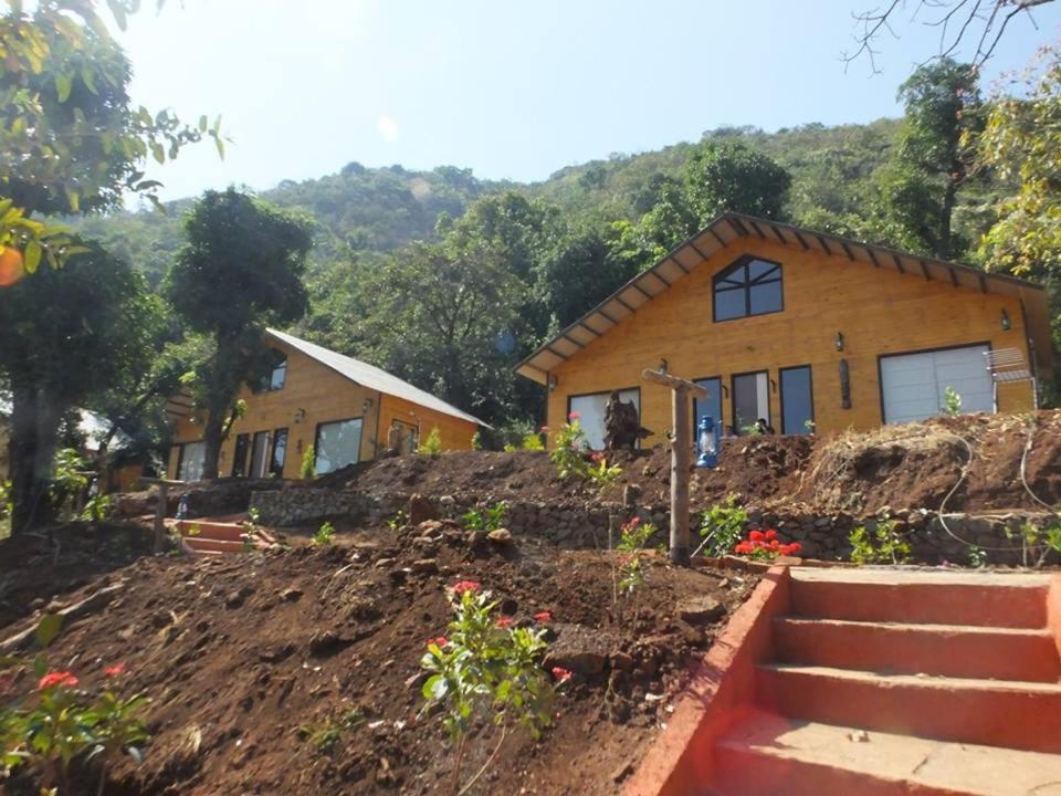 a house on top of a hill with a yard at I-Camp Resort in Mahabaleshwar
