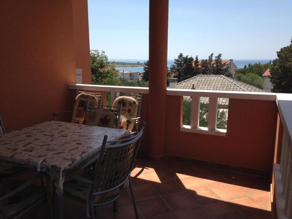 a table and chairs on a balcony with a view at Novalja Zrce Apartment in Novalja