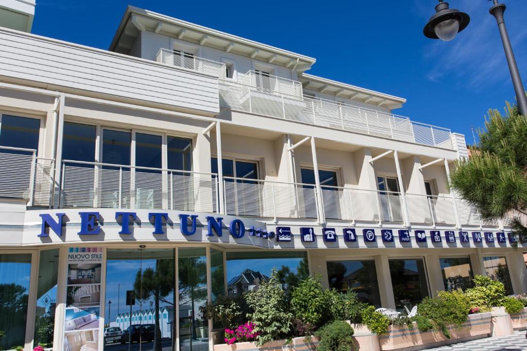 a building with a sign on the front of it at Hotel Nettuno in Cesenatico