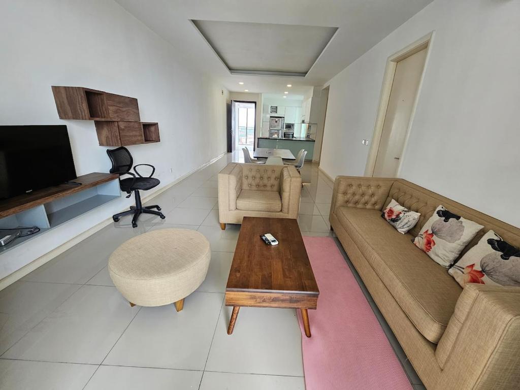 a living room with a couch and a coffee table at Modern Family Suites 3 bedroom in Melaka