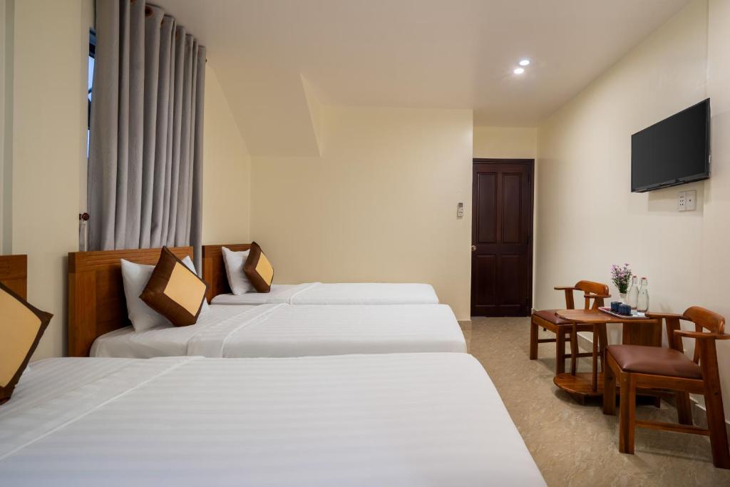 Postel nebo postele na pokoji v ubytování Sun Moon Riverside Hoi An