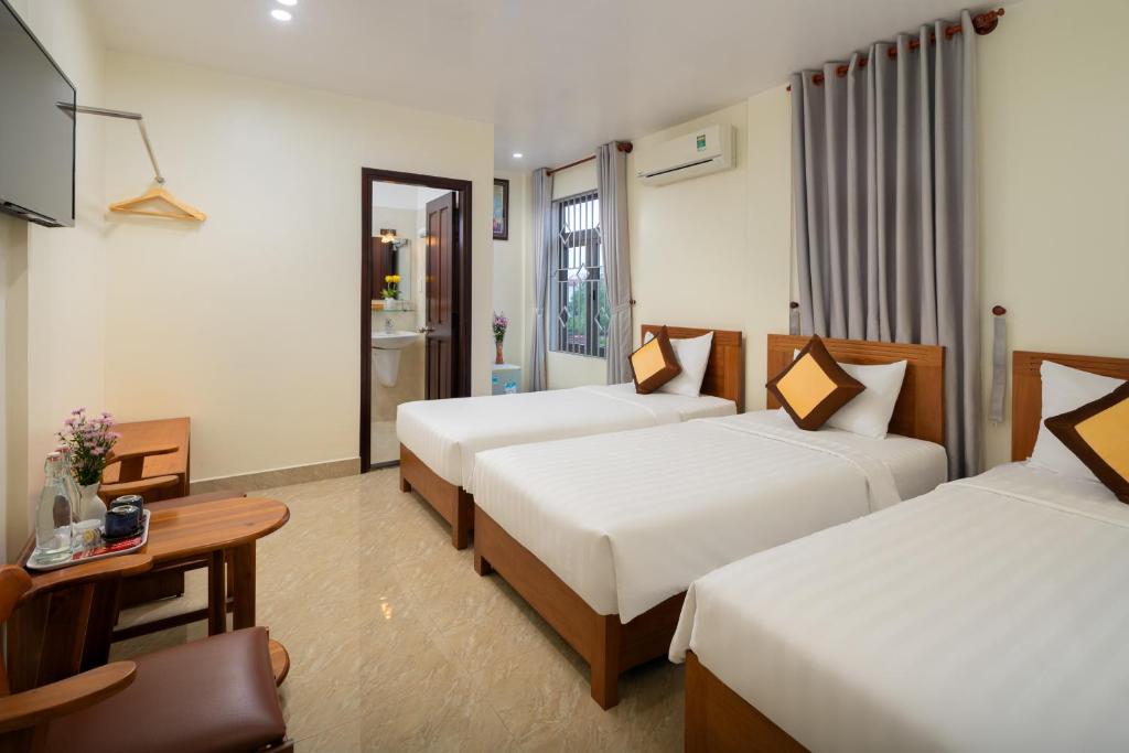 Postel nebo postele na pokoji v ubytování Sun Moon Riverside Hoi An