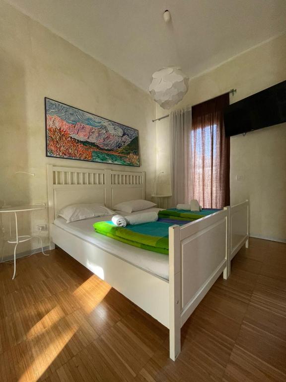 a bedroom with a large white bed in a room at Residence Bed&Bike in Moggio Udinese