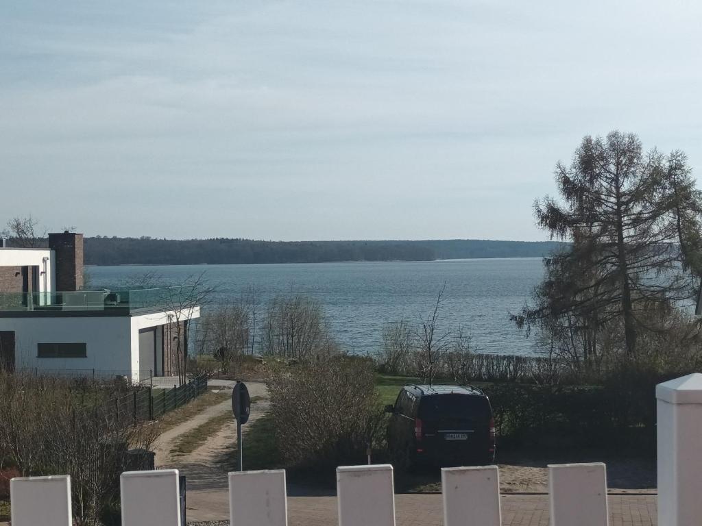 a car parked next to a house with a view of the water at Haus Seeblick in Alt Schwerin