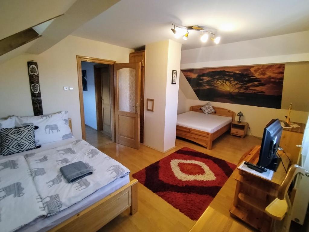 A bed or beds in a room at Elza Apartman