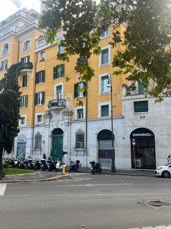 a large building with motorcycles parked in front of it at Lungotevere Testaccio 6 Roma - Apartments in Rome