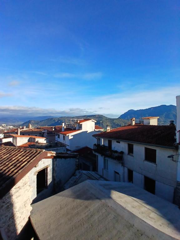 a view of a city from the roofs of buildings at b&b s'antalena in Orgosolo