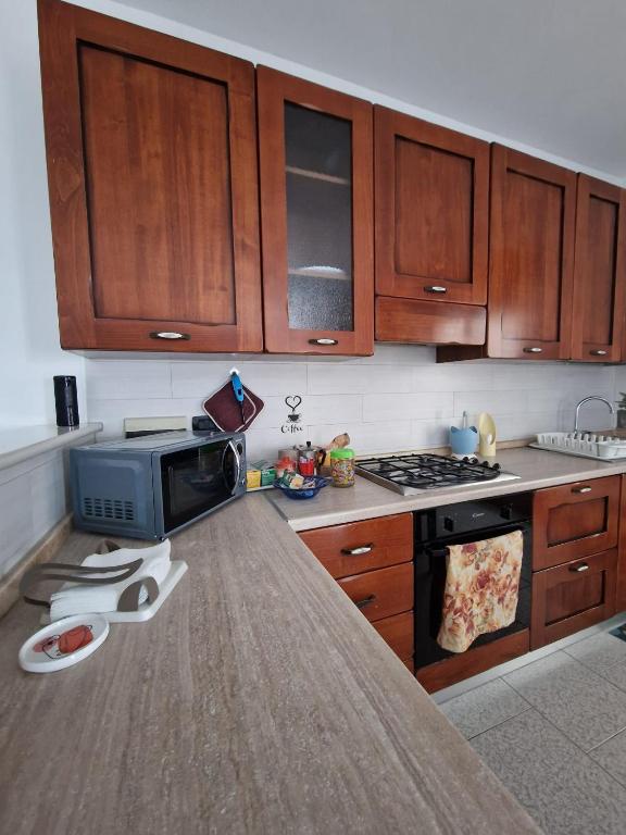 a kitchen with wooden cabinets and a counter top at Vista Monte Retreat in Reggio di Calabria