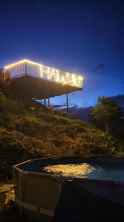 un edificio con luci in cima a una collina di Hawun Glamping with Private Pool a Tamparuli