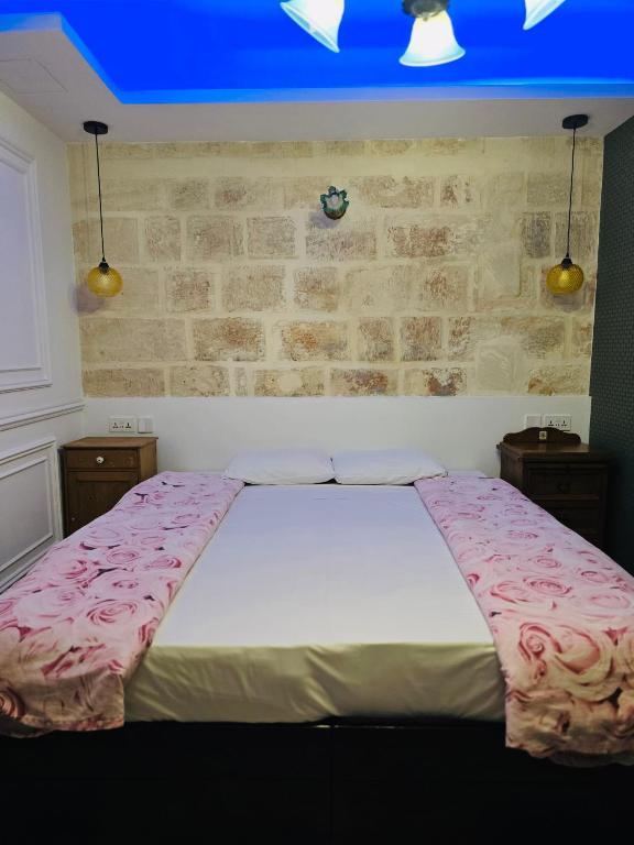 Postel nebo postele na pokoji v ubytování Luciano Valletta Boutique