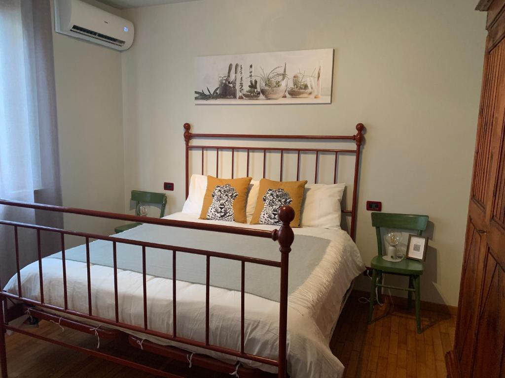 a bedroom with a bed with orange and white pillows at Casa Teresa Tuscany San Gimignano in Zambra