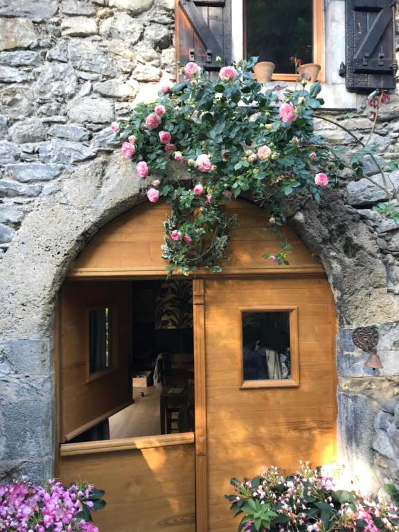 une porte avec une fleur au-dessus de celle-ci dans l'établissement les chalets de Maryline, à Accous