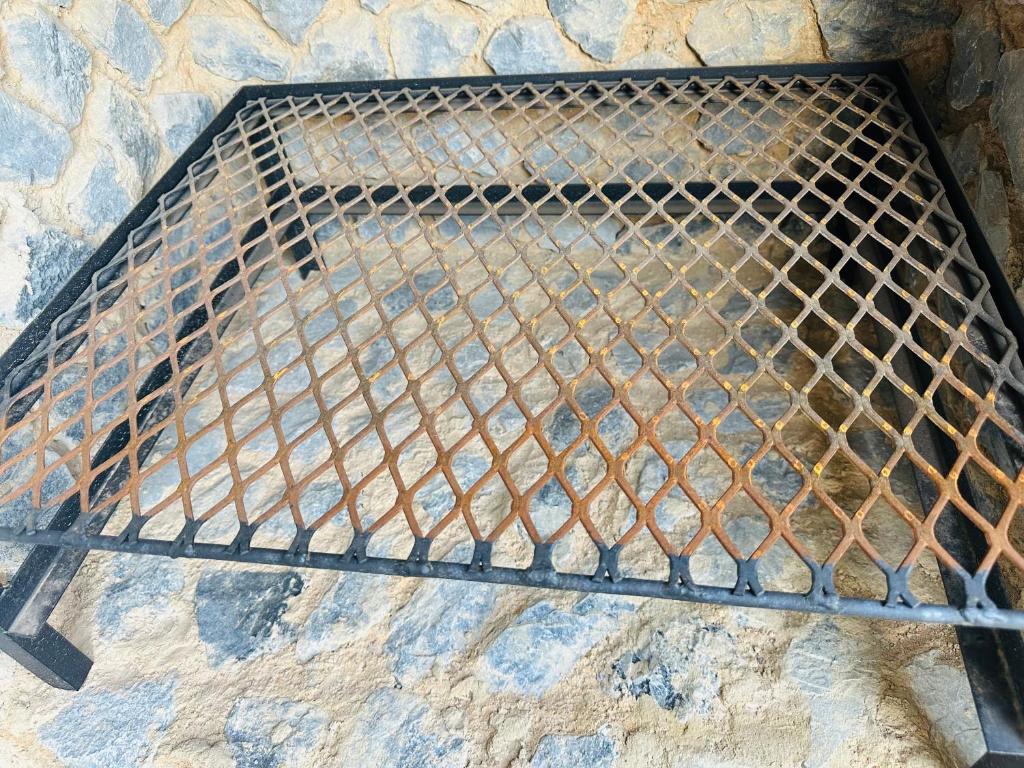 a metal grill sitting on top of a stone wall at Homely Stay 3 in Kempton Park