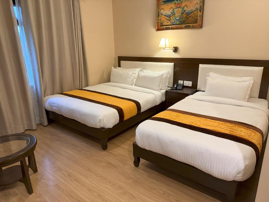 Postel nebo postele na pokoji v ubytování Hotel Shuman, Boudha