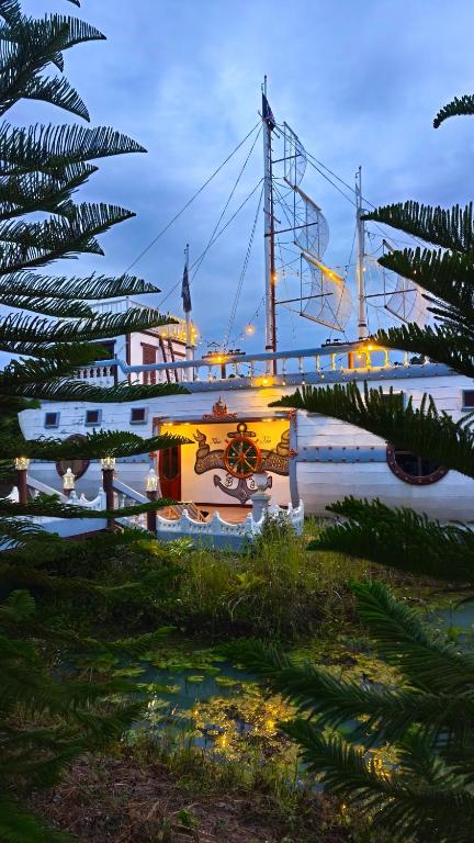 a large boat is docked in the water at Boat and House Resort Khao Kho in Khao Kho