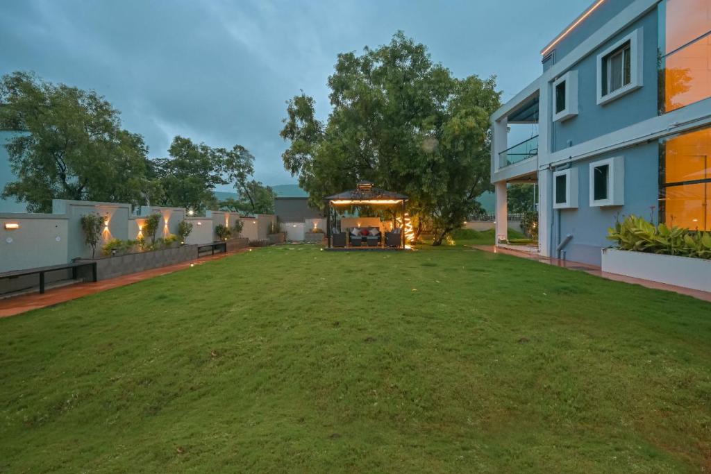 a large yard in the backyard of a house at Saanjh Villa 6 bhk in Khamshet