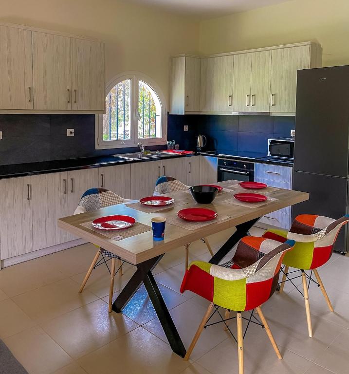 a kitchen with a wooden table and chairs at Nana's Luxury House in Nafpaktos