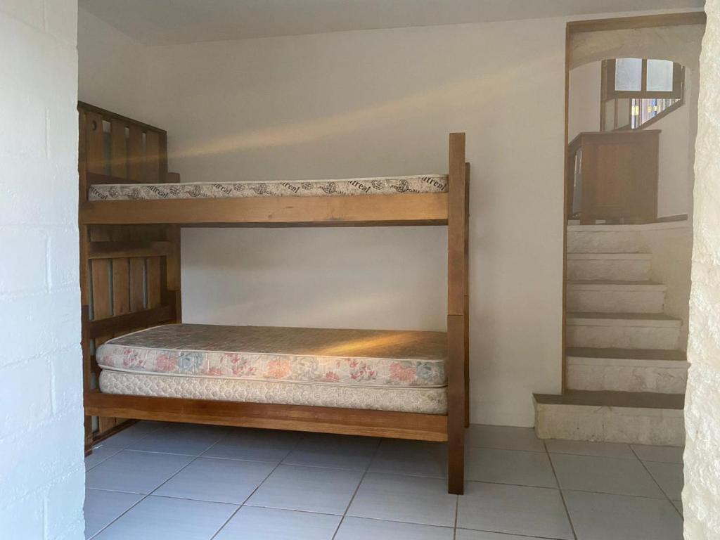 a bunk bed in a room with a staircase at Suíte Vista Azul in Ilhabela