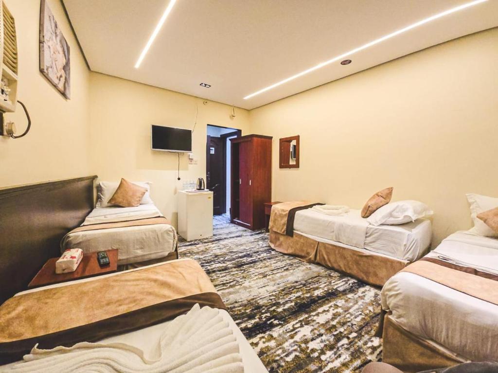 Postel nebo postele na pokoji v ubytování Jawad Al-Taj Hotel