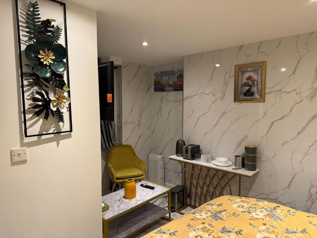 a room with a bed and a table and a chair at Luxury Studio in Victoria, 7 minutes walk to Victoria Station, Room 1 in London