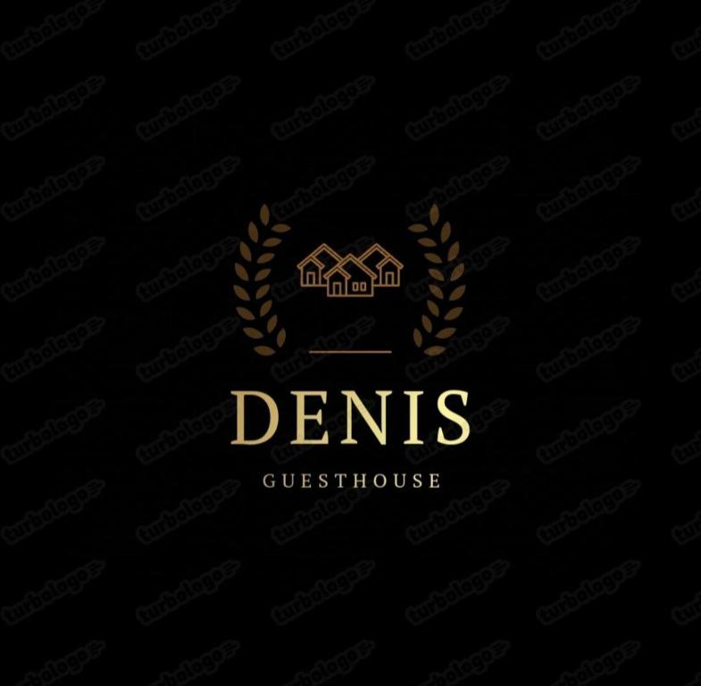 a gold logo with a house and a laurelreath at Guesthouse Denis in Kyzylemgek