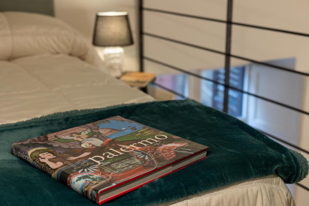a book sitting on top of a bed at Maison Castro Casetta a Palermo in Palermo