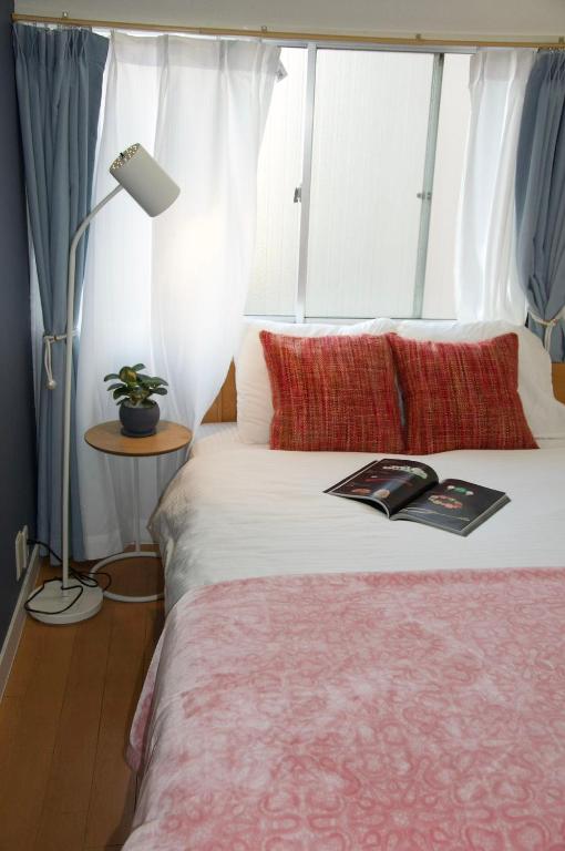 Postel nebo postele na pokoji v ubytování 全新装修南品川haven春